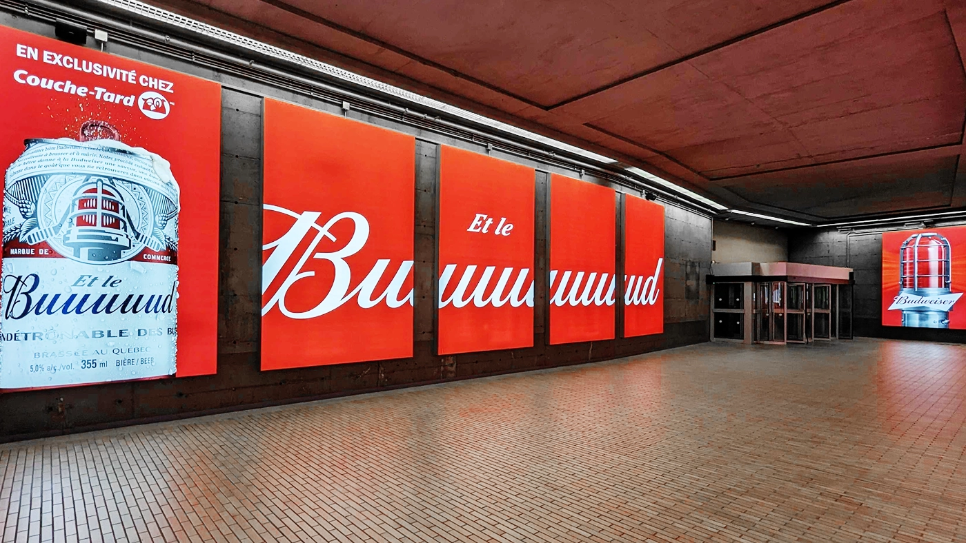 Modular SEG lightboxes with Budweiser campaign illuminating the underground pedestrian corridor at 1000 De La Gauchetière in Montreal.